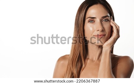 Beautiful female model, 40s years old, has perfect shiny, glowing body, facial skin, nourished and hydrated face after spa, cosmetic procedure, white background. Royalty-Free Stock Photo #2206367887