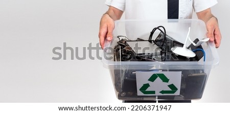 Hazardous E-Waste Recycling. Household electrical and scrapped electronic devices in recycle box. Sorting, disposing and recycling. Waste Electrical and Electronic Equipment. banner with copy space Royalty-Free Stock Photo #2206371947