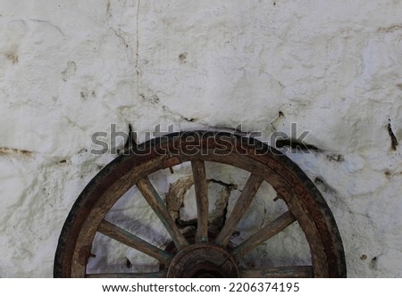 photo of wooden wheel decor on white wall
