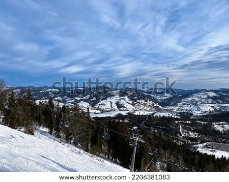 Ski Lift snowy mountain winter forest with chair lift At The Ski Resort in winter. Snowy weather Ski holidays Winter sport and outdoor activities Outdoor tourism 
