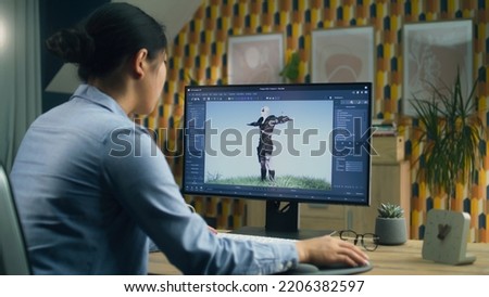 Asian female 3D designer making animation for video game character using modern computer with software for creating 3D modeling projects