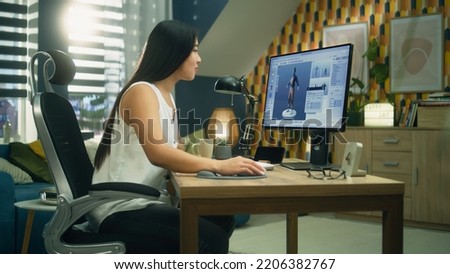 Asian 3D designer creating 3D model of style and design of clothes in professional program on personal computer while working remotely at home