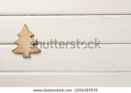 Wooden Christmas tree on wooden background, top view.