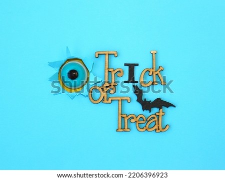 Funny treat for Halloween - jelly eye and wood lettering Trick or Treat.  Halloween decoration concept. 