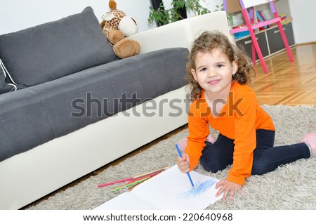 Young girl drawing with colored pencils