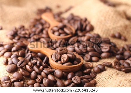 A coffee bean is a seed of the Coffea plant and the source for coffee. It is the pip inside the red or purple fruit often referred to as a coffee cherry. Just like ordinary cherries, the coffee fruit  Royalty-Free Stock Photo #2206415245
