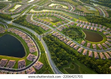 View from above of densely built residential houses near retention ponds in closed living clubs in south Florida. American dream homes as example of real estate development in US suburbs Royalty-Free Stock Photo #2206421701