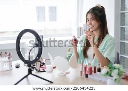 Beauty influencer concept, Young woman showing serum to introduce product and record video for Vlog. Royalty-Free Stock Photo #2206434223