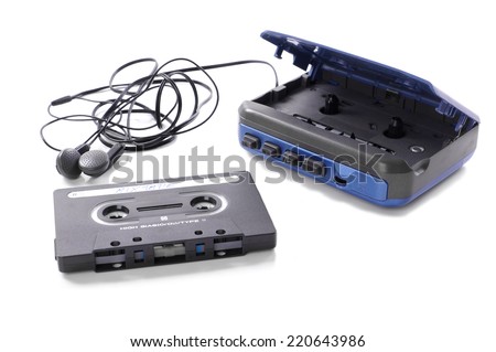 old-fashioned music cassette and walkman with earphones Royalty-Free Stock Photo #220643986