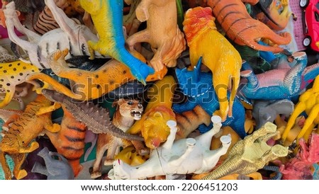 Hands on pile of various animal toys. Studio shot