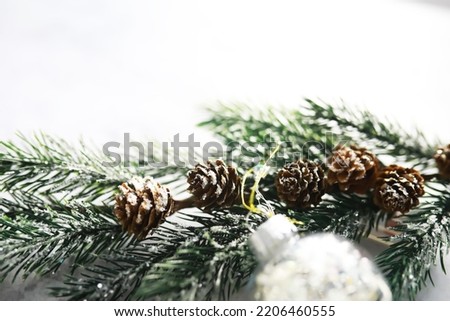 Evergreen tree handmade toys, snowflakes, globes and fir branch on stone background, Xmas greeting card with space for text