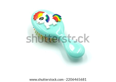 Bright children's Massage hairbrush on a white background it is isolated. High quality photo