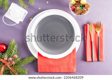 Beautiful top view of the New Year's empty plate. napkin with cutlery, Christmas decorations. a place to advertise your product