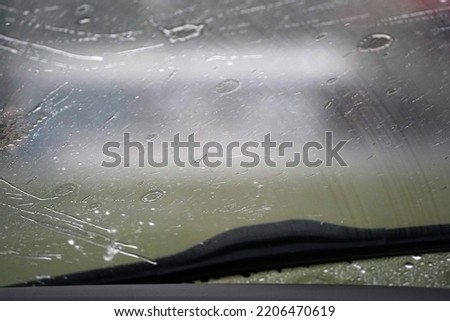 heavy rain on car windscreen wiper detail