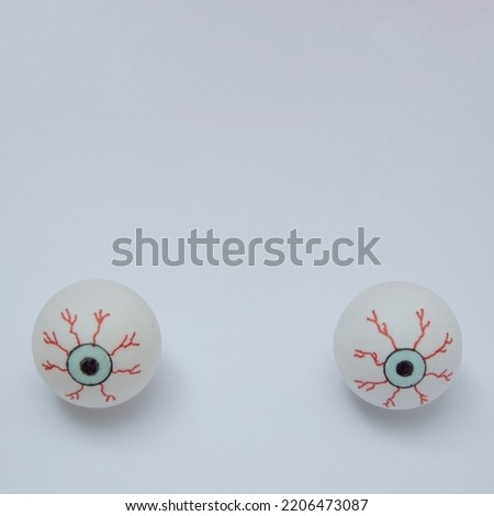 Creepy eyes on white background with copy space , Halloween holiday. Minimal aesthetic square concept.