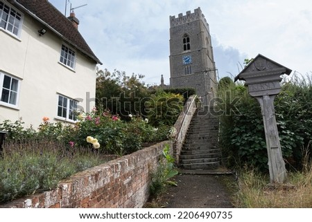 St Mary's Church, made of flint and stone in Kersey, Suffolk, UK. Village sign in front. Location of Magpie Murders