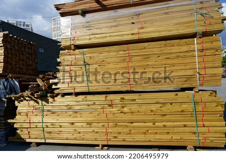 Blocks of pine sawn timber for the construction of roof houses and cottages stacked on the lumberyards site, ready for sale Royalty-Free Stock Photo #2206495979