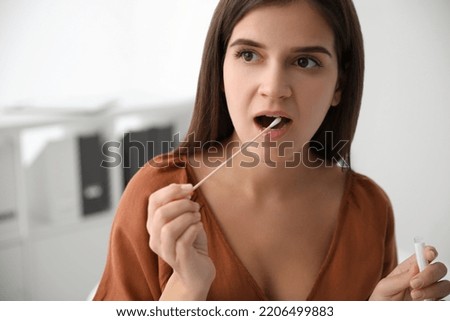 Woman taking sample for DNA test indoors Royalty-Free Stock Photo #2206499883