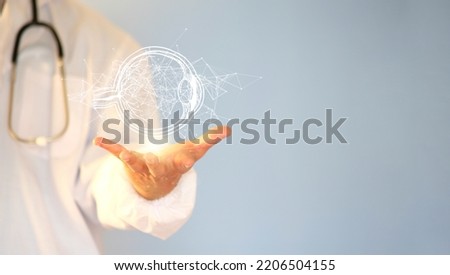 Doctor examines the patient's vision using a realistic human eye hologram. Modern ophthalmologist, vision concept, laser eye surgery, cataract, astigmatism, digital healthcare, and hologram network  Royalty-Free Stock Photo #2206504155