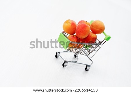Healthy eating concept. Shopping cart with freshness apricots