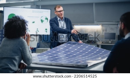 Chief Engineer Points at Projection Screen and Talks About Green Energy and Solar Panels Future Possibilities. Engineering and Sustainable Energy Higher Education Concept. Royalty-Free Stock Photo #2206514525