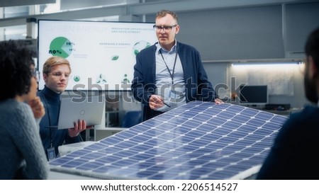 Team Meeting of Renewable Energy Engineers Working on an Innovative More Efficient Solar Panel Battery Concept. Group of Specialists Gathered Around Table, Solving Problems. Bright Research Facility. Royalty-Free Stock Photo #2206514527