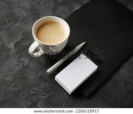 Blank business card, coffee cup, pen and usb flash drive.