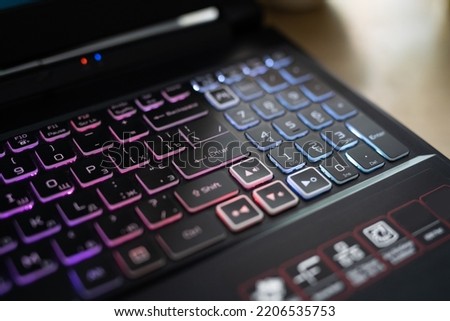 Color backlit keyboard close up. Gaming laptop.