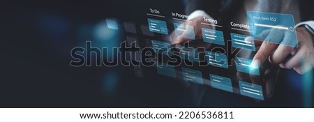 Agile software development. Business developer using computer with Kanban board framework on futuristic virtual screen interface, lean project management tool for fast changes concept Royalty-Free Stock Photo #2206536811