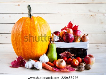 Autumn harvest of fruits and vegetables on a wooden background