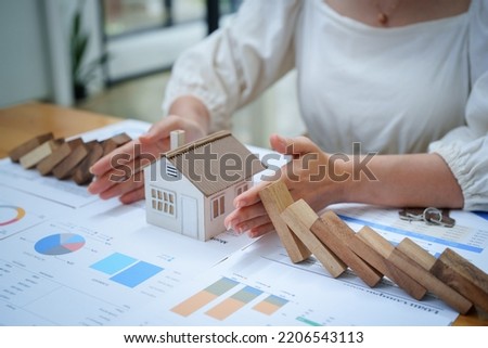 A portrait of a bank employee gesturing to protect a home from insurance to reduce the risk of investing, borrowing or buying a home