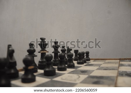 photo of black or white chess pieces during the day
