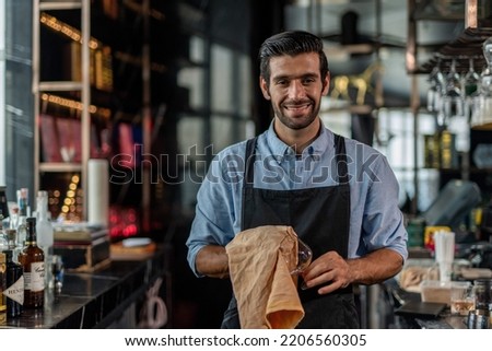 Photo of a handsome bartender behind the bar in a sky lounge bar in Bangkok Royalty-Free Stock Photo #2206560305