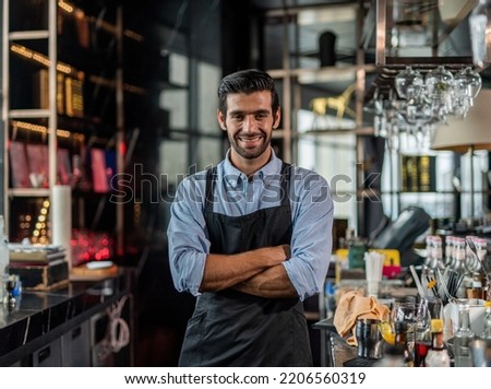 Photo of a handsome bartender behind the bar in a sky lounge bar in Bangkok Royalty-Free Stock Photo #2206560319