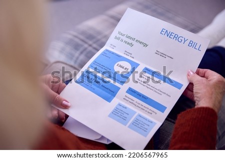 Close Up Of Senior Woman At Home Looking At USA Energy Bill During Cost Of Living Energy Crisis Royalty-Free Stock Photo #2206567965