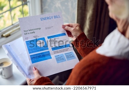 Close Up Of Senior Woman Opening UK Energy Bill Concerned About Cost Of Living Energy Crisis Royalty-Free Stock Photo #2206567971