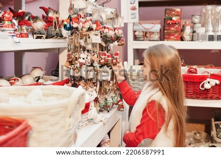 A girl choose the figurines for the Christmas tree