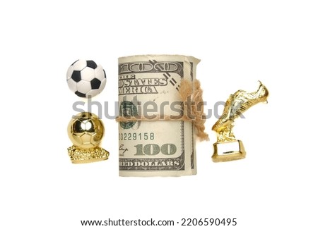 A picture of football ball, golden boot and ball with fake money.  Football fame and career concept.