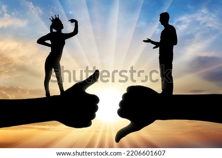 Selfishness and ego. An arrogant selfish woman with a crown on her head, considers herself better than a man. The concept of egoism and arrogance. Social problems. Silhouette Royalty-Free Stock Photo #2206601607