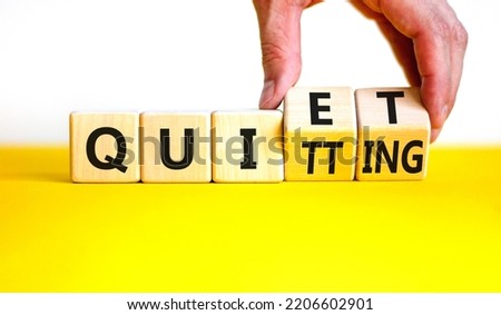 Quiet quitting symbol. Concept words Quiet quitting on wooden cubes. Businessman hand. Beautiful yellow table white background. Business quiet quitting concept. Copy space. Royalty-Free Stock Photo #2206602901