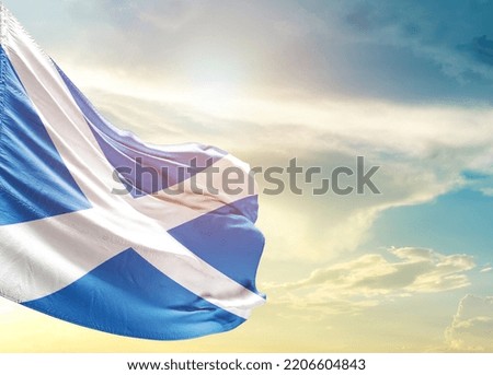 Scotland national flag waving in beautiful sky.