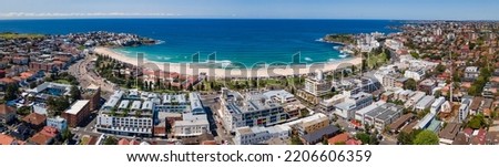Panoramic aerial drone view of iconic Bondi Beach in Sydney, Australia with the blue ocean in the background on a sunny day during spring 2022  