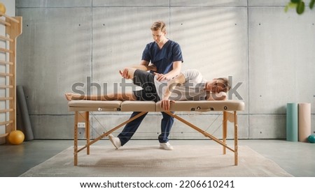 Sportsman Patient Undergoing Physical Therapy to Recover from Surgery and Increase Mobility. Physiotherapist Works on Specific Muscle Groups or Joints to Rehabilitate From Training Injury. Royalty-Free Stock Photo #2206610241