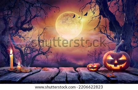 Halloween Table - Old Wooden Plank With Orange Pumpkin In Purple Landscape With Moonlight Royalty-Free Stock Photo #2206622823