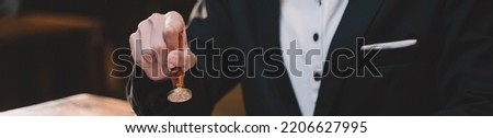 ฺBanner background of a seal to show approval of an agreement or contract by an authorized person. A businesswoman is about to stamp a document at the office legally.