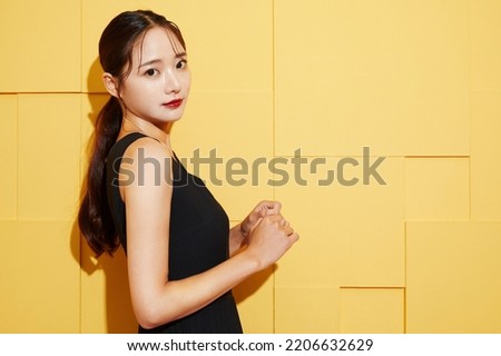 Fashion portrait of a young woman in a black dress