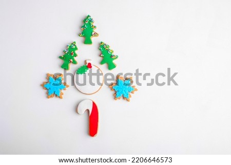 Christmas gingerbread cookies in the shape of a Christmas tree on a white background. Alternative Edible Christmas Tree, Top view, flat lay