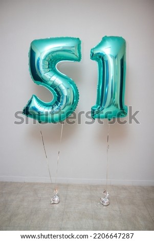 foil balloons numbers mint color on the background of the wall