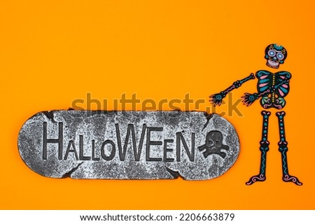 Happy Halloween holiday concept. Orange Halloween background design decorations, bats, patterns skeletons sign that says Halloween. poster, greeting card mockup, website header template, copy space
