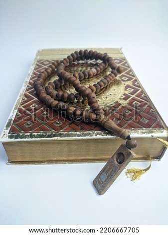 Islamic Concept.Flat lay composition with Muslim prayer beads, Al Quran on isolated white background

